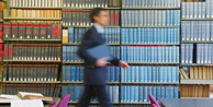man walking through library