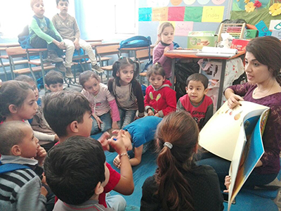 Syrian refugee children enjoy a reading activity in Lebanon