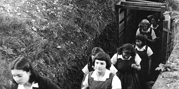 Girls at Bedales School emerging from their air-raid shelter after a raid