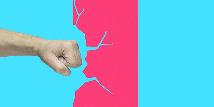 Man's fist punching red illustrated wall on blue background