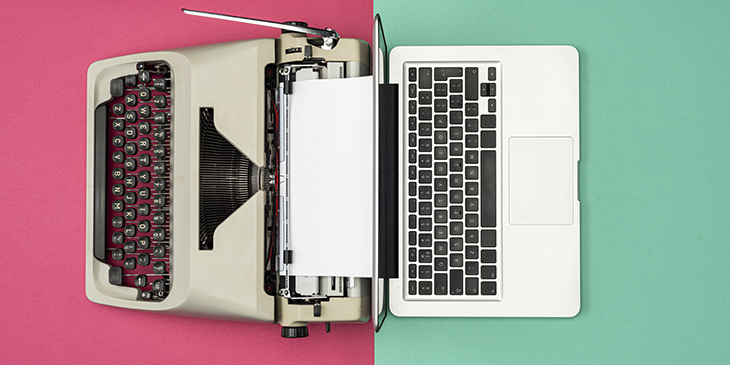 Classic analog typewriter vs Modern digital hi-tech laptop computer