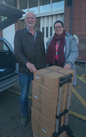 CRRC Trustee Adrian Matthews recieving Cambridge laptops