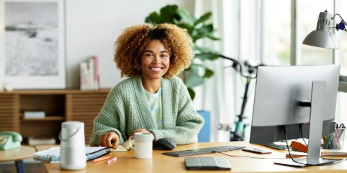 Professional happily working at her computer