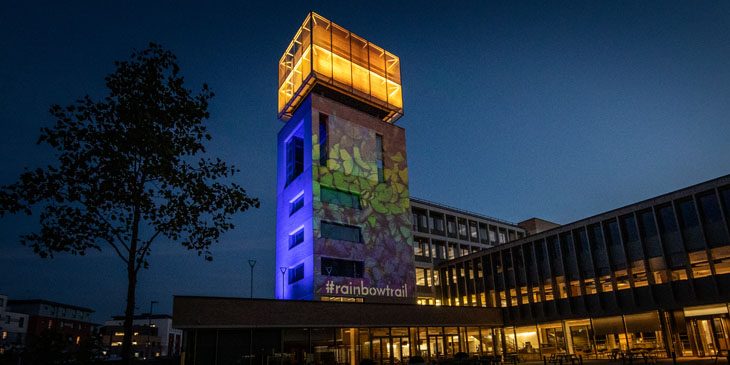 The Tower at our international headquarters lit up in blue with a quote by Stephen Hawking projected on to it in white