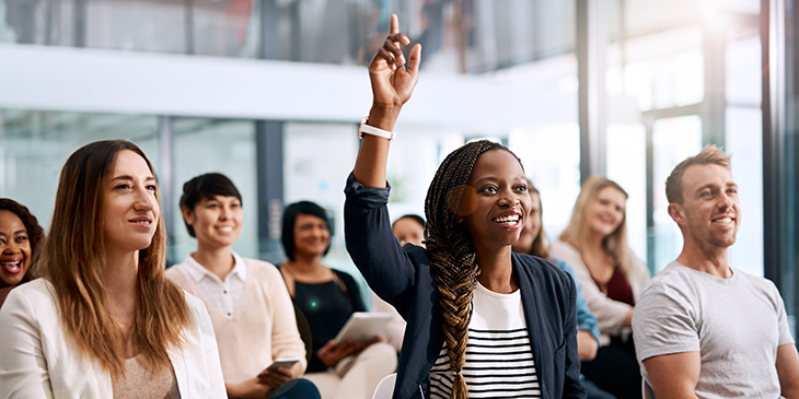 Woman at training event with hand up