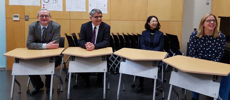 Simon Japan blog four of team at desks in school 2018 full width image