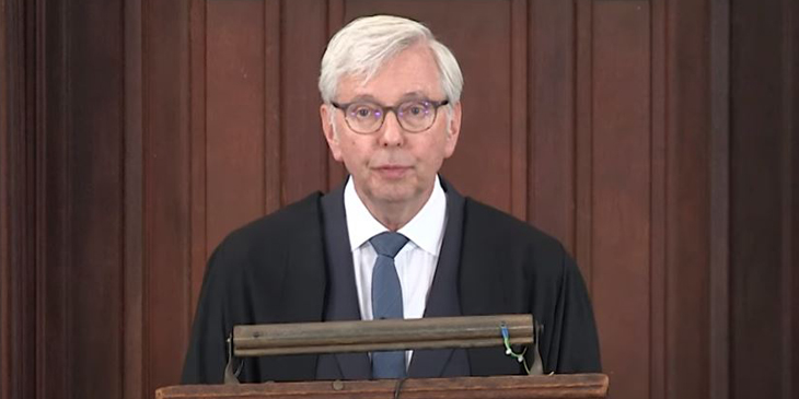 Vice chancellor of the University of Cambridge stands at a lectern in the Senate House to give his annual address to the University