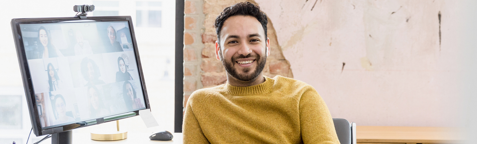 Man in office smiling at camera