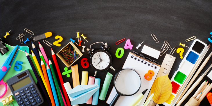 a collection of brightly coloured school equipment including pens pencils scissors and a calculator on a black background