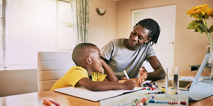 Father supporting child with school work