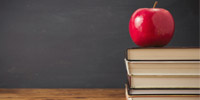 An apple sitting on books