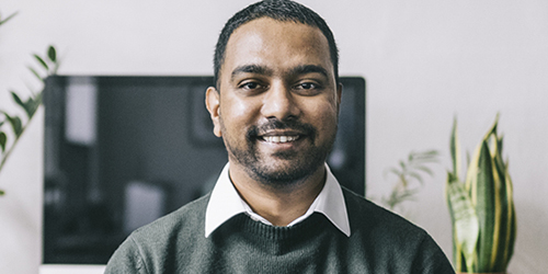 Man in office smiling at camera