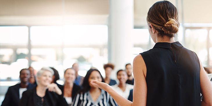 Woman standing in front of an audience