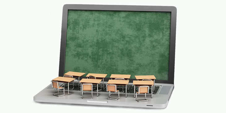 Laptop with exam hall desks and chairs over the keyboard