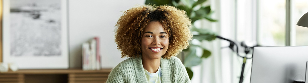 Woman in office smiling at camera