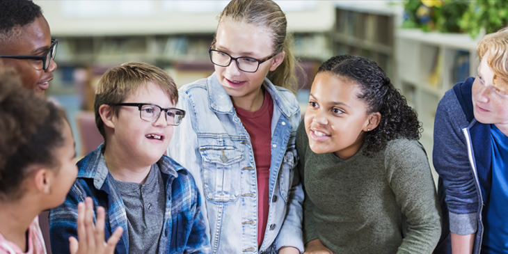 group of children talking in a classroom