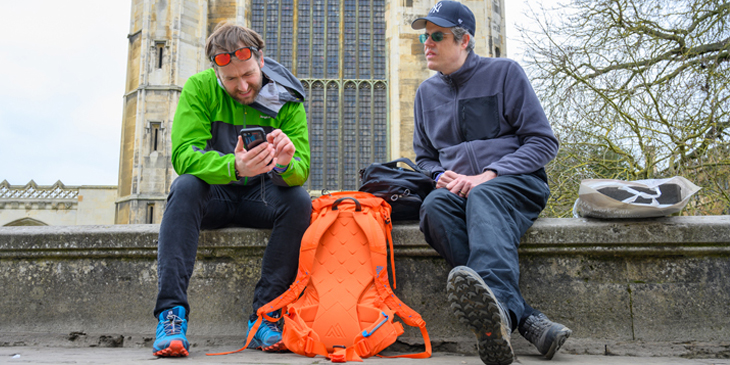 James Ketchell and Mark Woods Nunn sat on a wall in front of kings college chapel in Cambridge in the United Kingdom